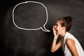 Portrait of young girl with speech bubble on chalkboard