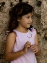 Portrait of young girl standing near the rock. Happy childhood. Spending time on the beach. Vacation in Asia. Pandawa beach, Bali Royalty Free Stock Photo