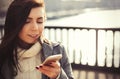 Portrait of young girl using her trendy smart phone Royalty Free Stock Photo