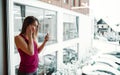 A portrait of young girl or woman with earphones and smartphone in a gym.