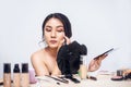 Young Asian woman applying makeup. Royalty Free Stock Photo