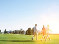 Portrait of young golfers walking on the golf course Royalty Free Stock Photo