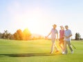 Portrait of young golfers walking on the golf course Royalty Free Stock Photo