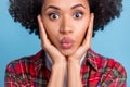 Portrait of young good looking flirty amazed afro woman pout lips kiss isolated on blue color background