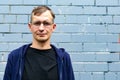 Portrait of young goodlooking man against grey brickwall. Royalty Free Stock Photo