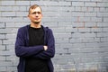 Portrait of young goodlooking man against grey brickwall. Royalty Free Stock Photo