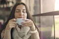 Portrait of young gorgeous female drinking cup of coffee and enjoying her leisure time alone Royalty Free Stock Photo