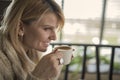 Portrait of young gorgeous female drinking cup of coffee and enjoying her leisure time alone Royalty Free Stock Photo