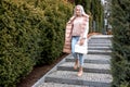 Portrait of young gorgeous serious woman with long grey hair with make-up standing in white, pink reversible jacket. Royalty Free Stock Photo