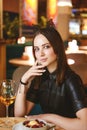 Portrait of young gorgeous woman drinking champagne in a glass and looking with smile, eating ice cream fruit dessert. Royalty Free Stock Photo