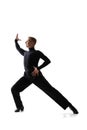 Portrait of young graceful male dancer, flexible man in black stage costume dancing ballroom dance isolated on white Royalty Free Stock Photo