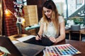 Portrait of young graphic designer working on new project using graphics tablet and laptop sitting in modern office Royalty Free Stock Photo