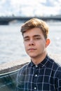 Portrait of young guy, brunette with dark hair, Caucasian. Close - up of a guy, boy, man looking at camera. Outdoor in city by Royalty Free Stock Photo