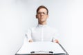 Portrait of a young guy in glasses, in a white shirt, shows an empty folder on the camera , isolated on a white background, for ad