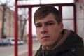 Portrait of a young guy 21-22 years old at a bus station close-up Royalty Free Stock Photo