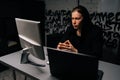 Portrait of young hacker man wearing long-sleeved shirt stealing information, preparing to break password sitting at Royalty Free Stock Photo