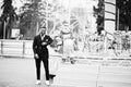 Portrait of young and handsome african american businessman in suit pose background carousel attractions