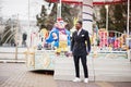 Portrait of young and handsome african american businessman in suit pose background carousel attractions