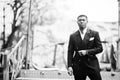 Portrait of young and handsome african american businessman in suit pose background carousel attractions