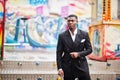 Portrait of young and handsome african american businessman in suit pose background carousel attractions