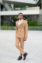 Full body shot of young handsome African businessman thinking in the city outdoors Royalty Free Stock Photo