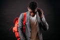 Portrait of young handsome African man with pinck backpack and headphones