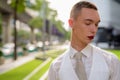 Young androgynous homosexual LGTB businessman wearing lipstick