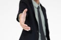 Portrait of young and handsome Asian businessman in a black suit pose with smile face and giving hand for shake with self- Royalty Free Stock Photo