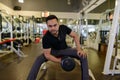 Full body shot of young bearded Indian man lifting weights at the gym Royalty Free Stock Photo