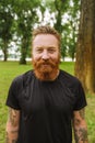 Portrait of young handsome bearded tattooed redhead smiling man Royalty Free Stock Photo