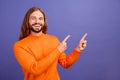 Portrait of young handsome blond long hair man wearing orange trendy sweater direct finger novelty isolated on purple Royalty Free Stock Photo