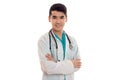 Portrait of young handsome brunette man doctor in white uniform with stethoscope looking at the camera and smiling Royalty Free Stock Photo