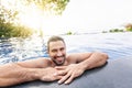Portrait of a young handsome brutal latin man in an outdoor pool Royalty Free Stock Photo