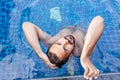 Portrait of a young handsome brutal latin man in an outdoor pool Royalty Free Stock Photo