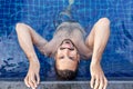 Portrait of a young handsome brutal latin man in an outdoor pool Royalty Free Stock Photo