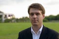 Portrait of young handsome businessman at the park