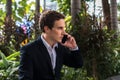 Portrait of young handsome businessman talking on the phone at the park Royalty Free Stock Photo