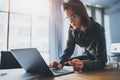 Portrait of Young handsome businesswoman using laptop computer at modern office.Blurred background. Royalty Free Stock Photo