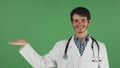 Male doctor smiling holding copy space on his hand