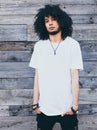 Portrait young handsome fashion bearded afro hair model black man in urban. Dressed in a white t-shirt. Afro Hairstyle. Old wood b Royalty Free Stock Photo