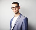 Portrait of young handsome man wearing glasses over grey background Royalty Free Stock Photo