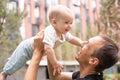 Portrait of young handsome father holding his adorable cute newborn baby boy. Lifestyle. Real people. Fatherhood and Royalty Free Stock Photo