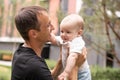 Portrait of young handsome father holding his adorable cute newborn baby boy. Lifestyle. Real people. Fatherhood and Royalty Free Stock Photo