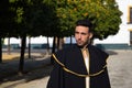 Portrait of young and handsome gipsy man, dressed in black and red shoes and with a black and yellow bullfighter`s cape over his Royalty Free Stock Photo