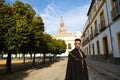 Portrait of young and handsome gipsy man, dressed in black and red shoes and with a black and yellow bullfighter`s cape over his Royalty Free Stock Photo