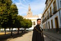 Portrait of young and handsome gipsy man, dressed in black and red shoes and with a black and yellow bullfighter`s cape over his Royalty Free Stock Photo