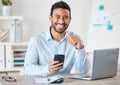 Portrait of a young handsome happy mixed race businessman using social media on his phone while working alone on a Royalty Free Stock Photo