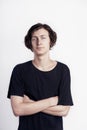 Portrait of young handsome hipster man look surprised disappointment, black t-shirt, white background