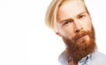 Portrait of young handsome hipster man with red beard looking at camera over white background. Royalty Free Stock Photo