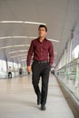 Young handsome Hispanic businessman walking on the footbridge Royalty Free Stock Photo